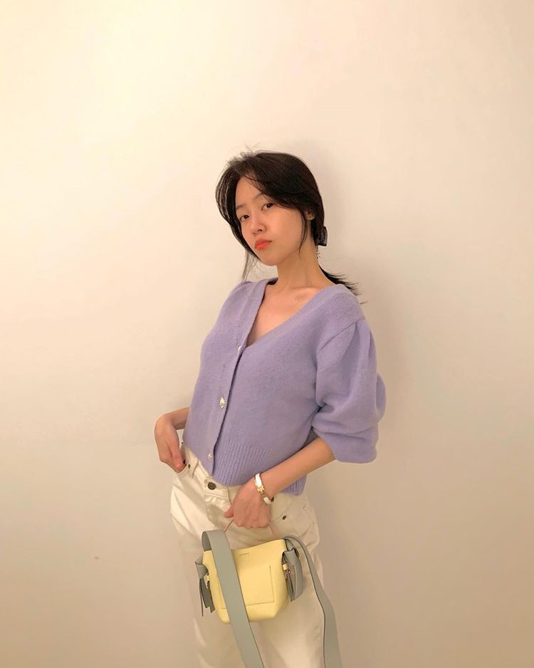 Minah, wearing a light purple knit, smiling eyes