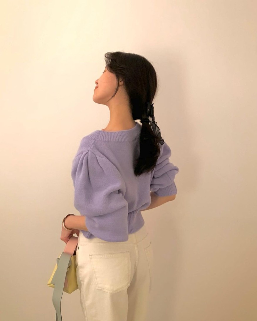 Minah, wearing a light purple knit, smiling eyes